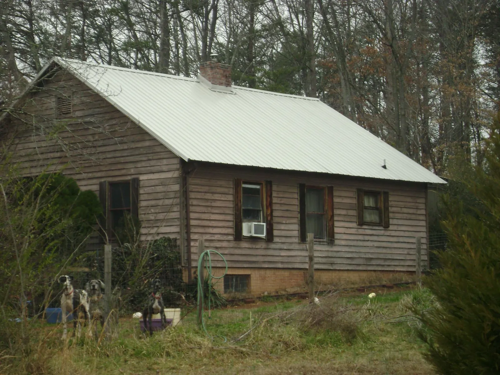 White metal roof on an old wood sided farmhouse, from a Metal Roof Installation job in Lost Nation